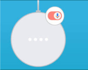 Close-up of the back of a Google Nest Hub showing the physical microphone switch toggled to the orange position, indicating the device is muted.