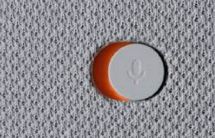 Close-up of the physical privacy switch on the back of a Google Nest device, showing the orange color that indicates the microphone is muted.